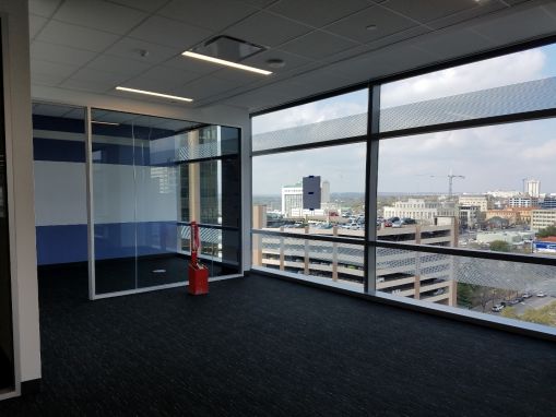 A photo from the 11th floor.  A Huddle Room is on the left.  The white band is a markable wall surface.