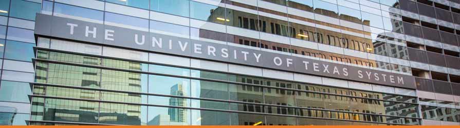 Closeup photo of the building's exterior signage that reads: The University of Texas System 