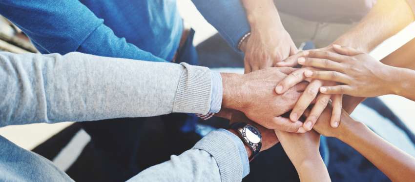 A group of people stacking hands