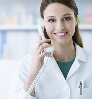 Female nurse with a phone pressed to her ear