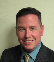 Headshot of Roger Stearns in a suit