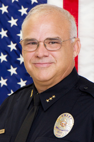 Robert Dahlstrom in his uniform in front of an American flag.