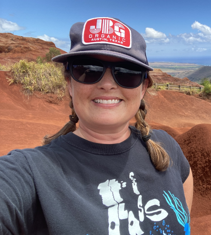 Angela Ossar smiling in front of landscape.