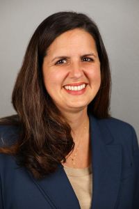 Profile photo of Jennifer Evans-Cowley in a blue coat and smiling